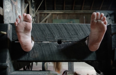 Blonde female Delirious Hunter is restrained in a variety of ways